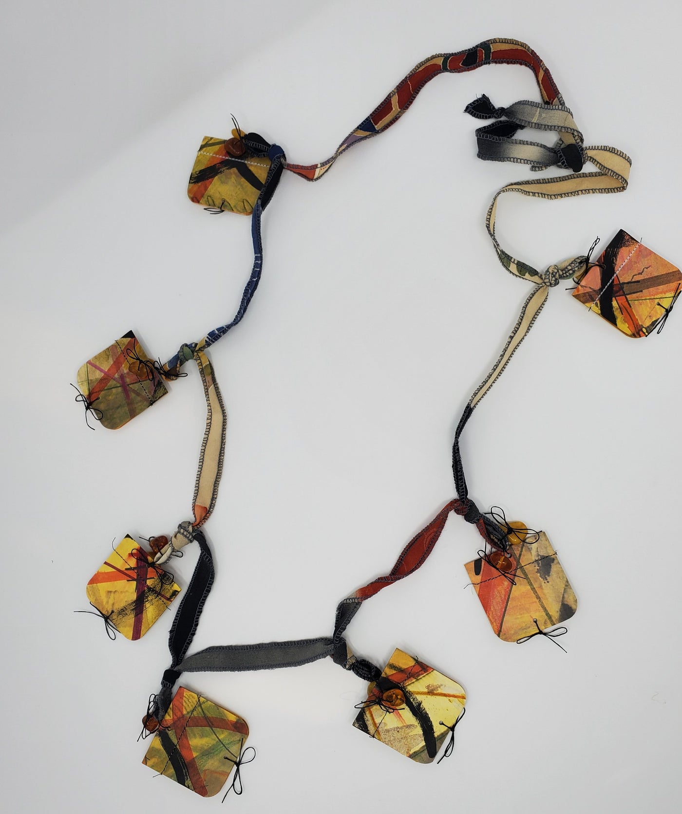 Folded Handmade Paper Squares on Long Fabric Cord Necklace by Zia Gipson